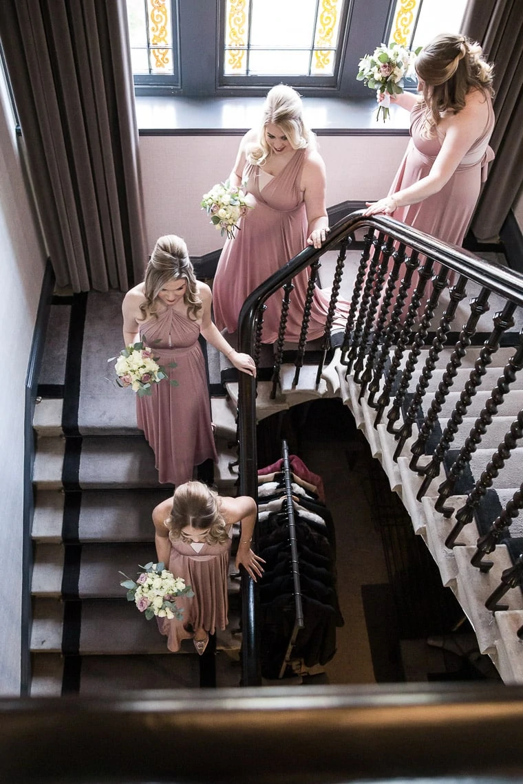 bridesmaids making their way down the staircase
