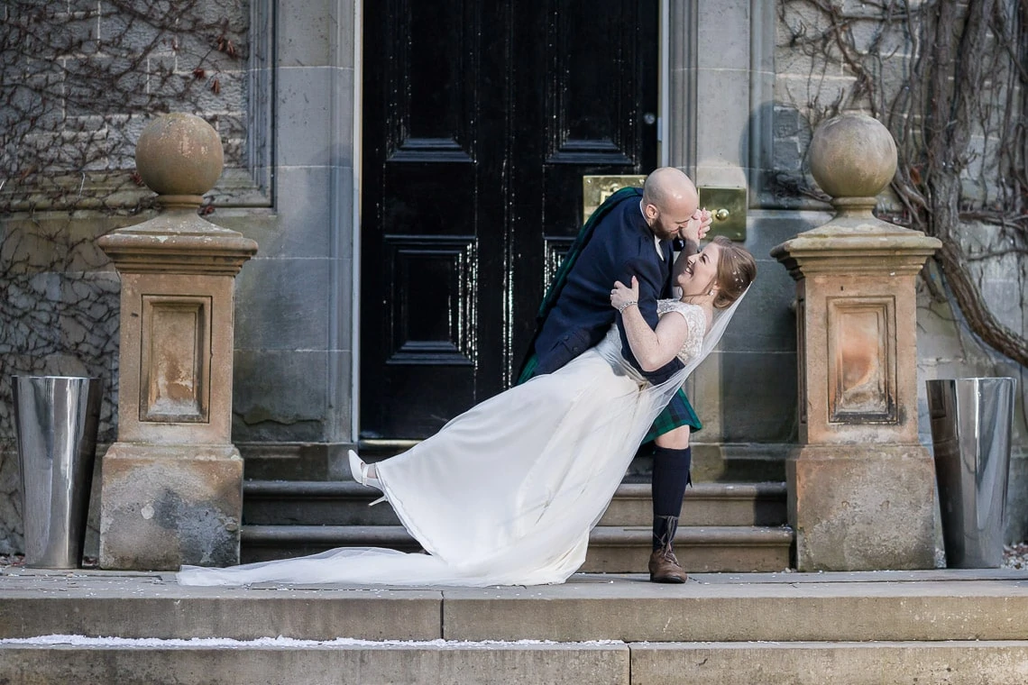 newlyweds kissing on the steps