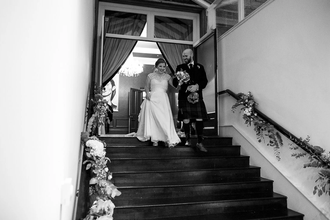 bride and groom are announced into The Orangery and walk down the steps