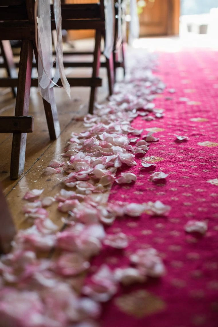 Chapel - flower petals scattered on the aisle floor