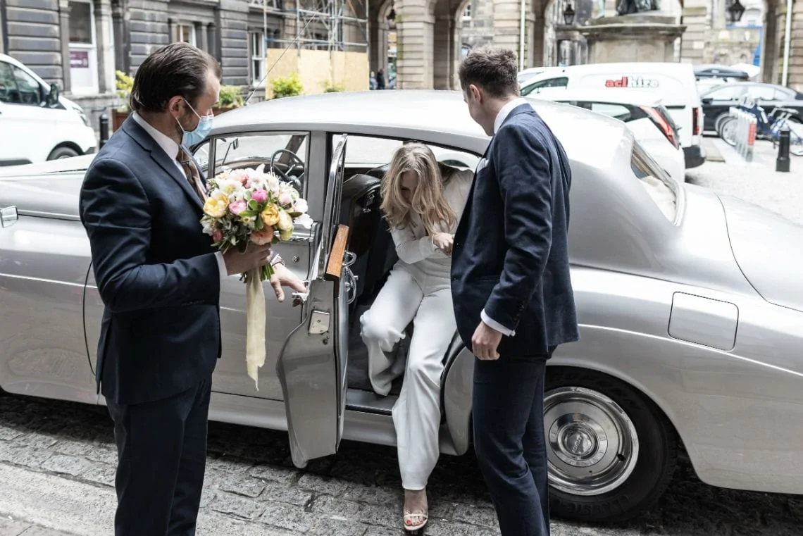 bride exiting a classic car in the Quadrant