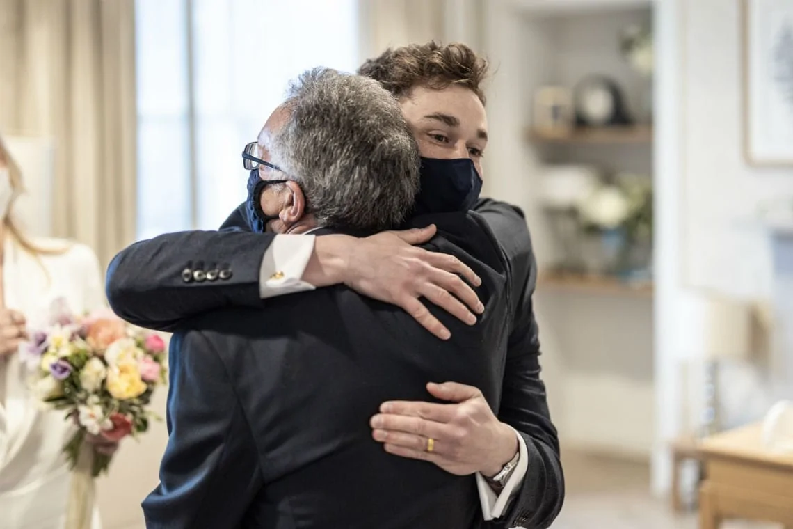 groom hugged by his father