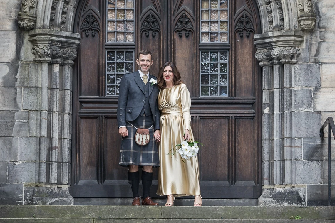 newlyweds holding hands at the rear of St Giles' Cathedral