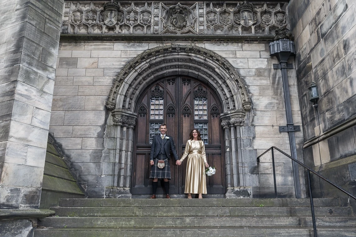 newlyweds holding hands at the rear of St Giles' Cathedral