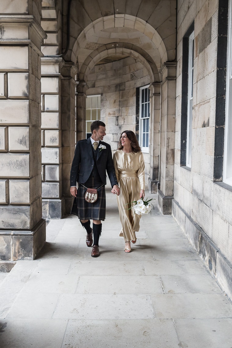 newlyweds walking under the arches at The Signet Library