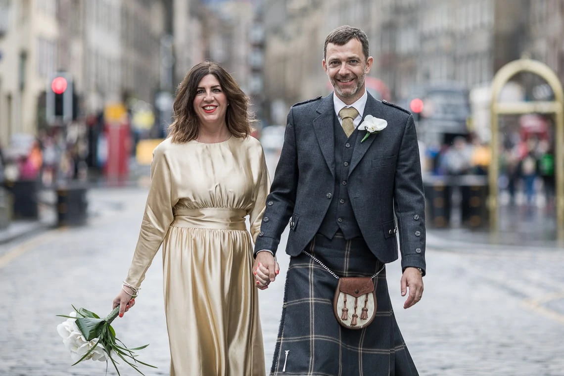newlyweds walking down The Royal Mile