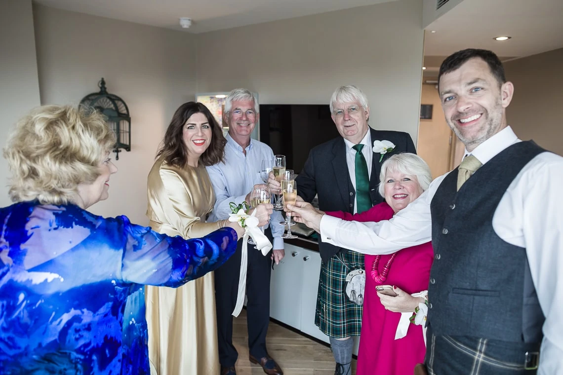 bride, groom and parents raise a toast at Radisson Hotel