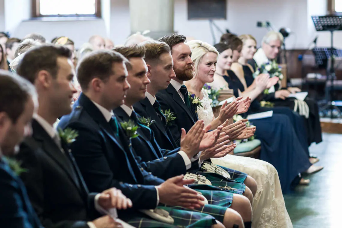 Bridal party clapping during wedding ceremony