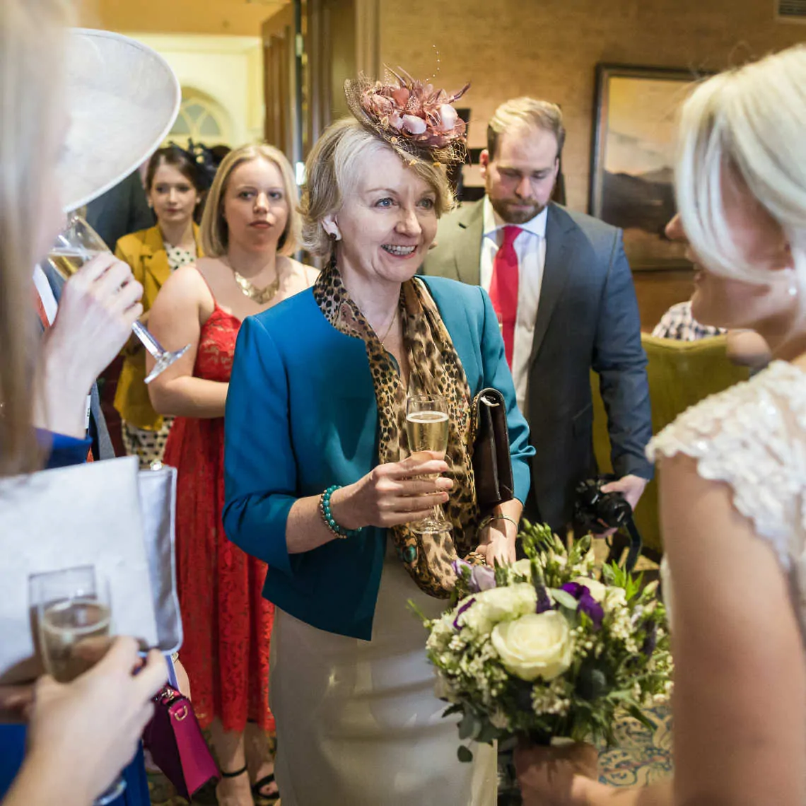 Guest smiling at bride at drinks reception