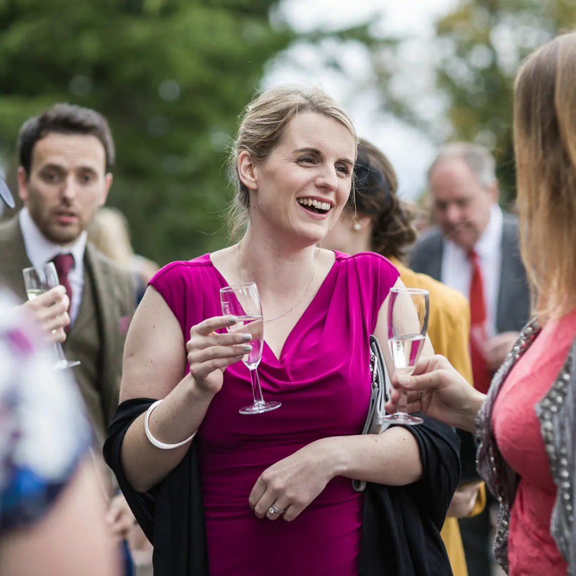 Lady laughing at outdoor drinks reception