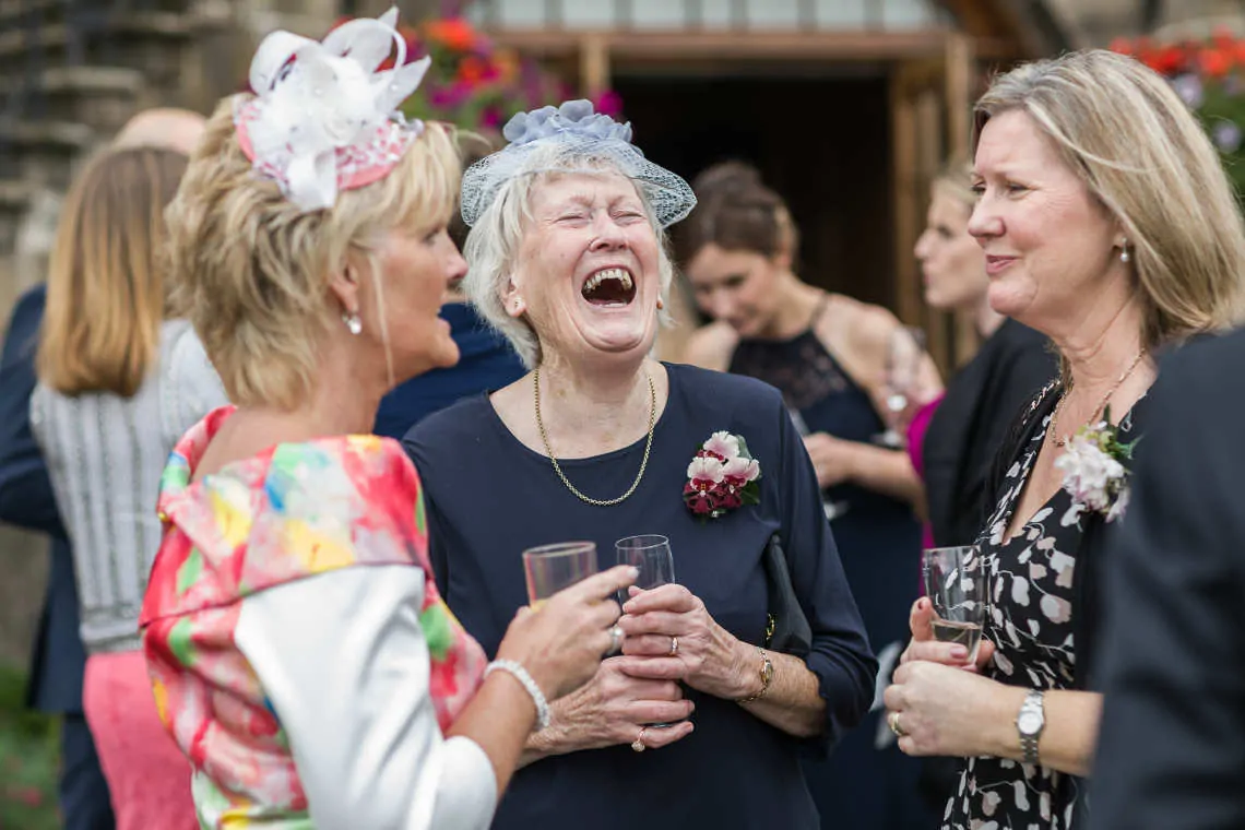 Lady laughing during outdoor drinks reception