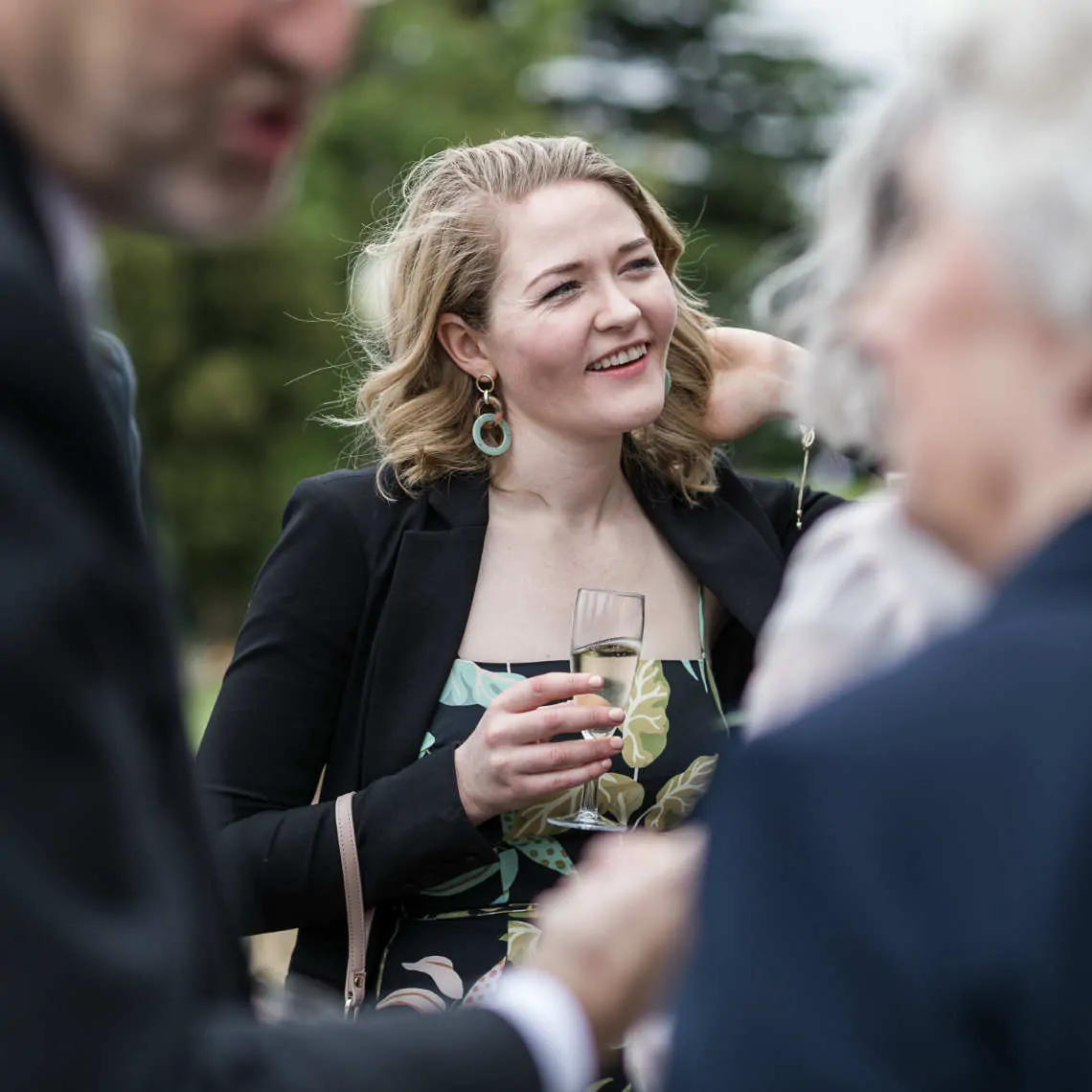 Lady smiling at outdoor drinks reception