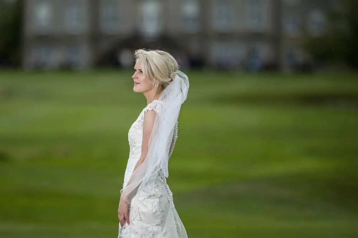 Side bridal pose with Dalmahoy Hotel in the background