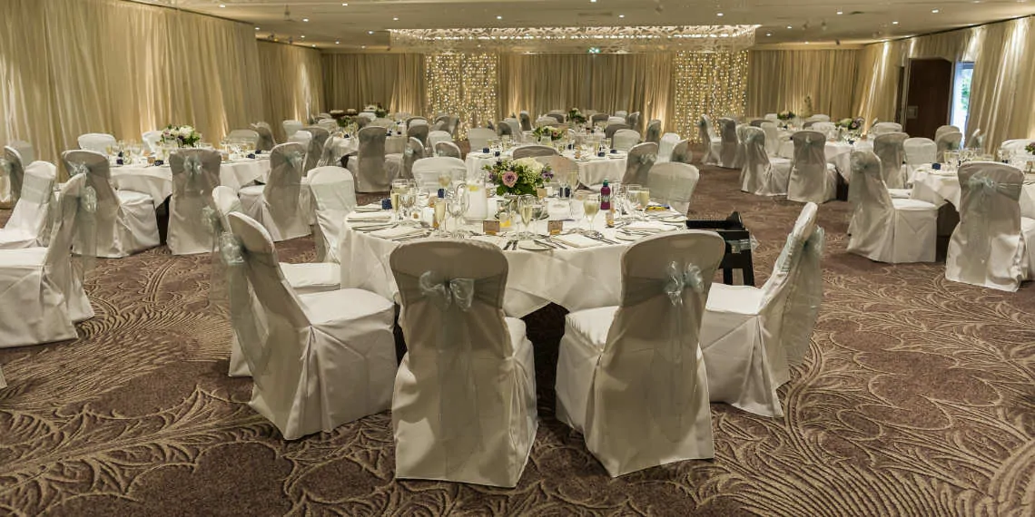 Wide angle view of the Dalmahoy Suite set for wedding breakfast