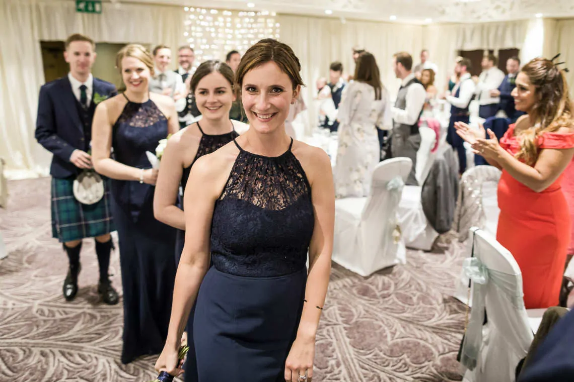 Close up of bridesmaid as she walks to the top table at reception