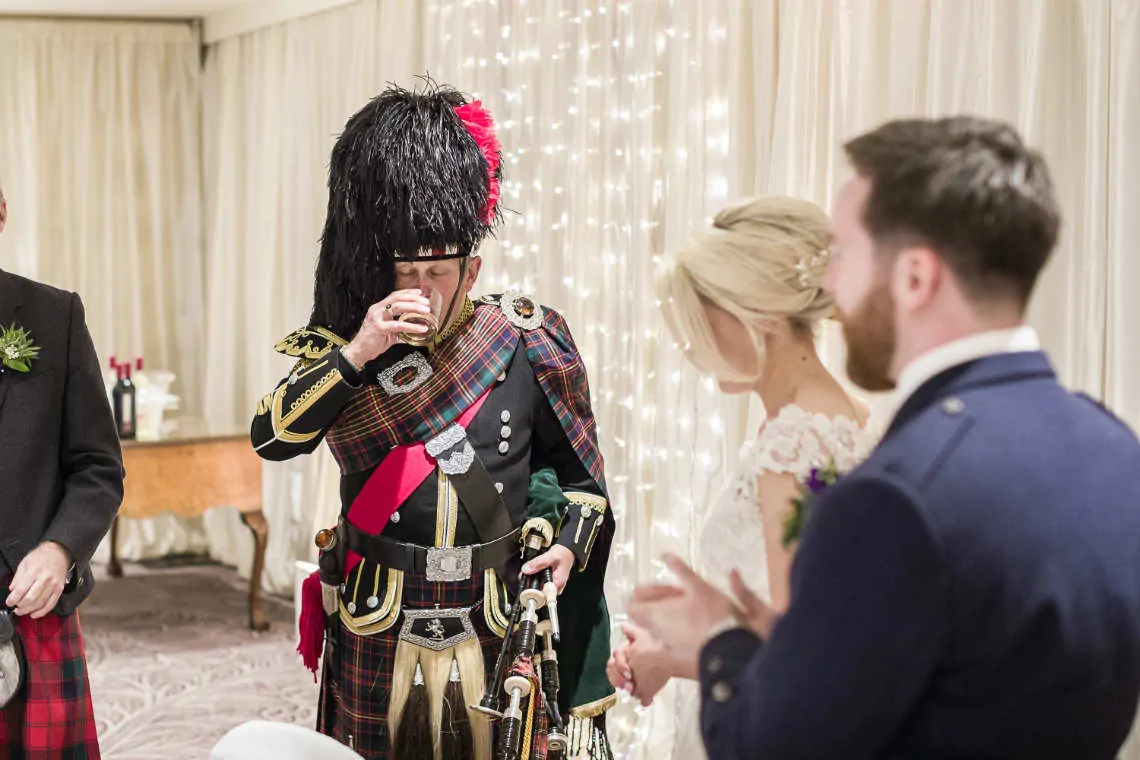 Piper takes a sip of his dram at reception