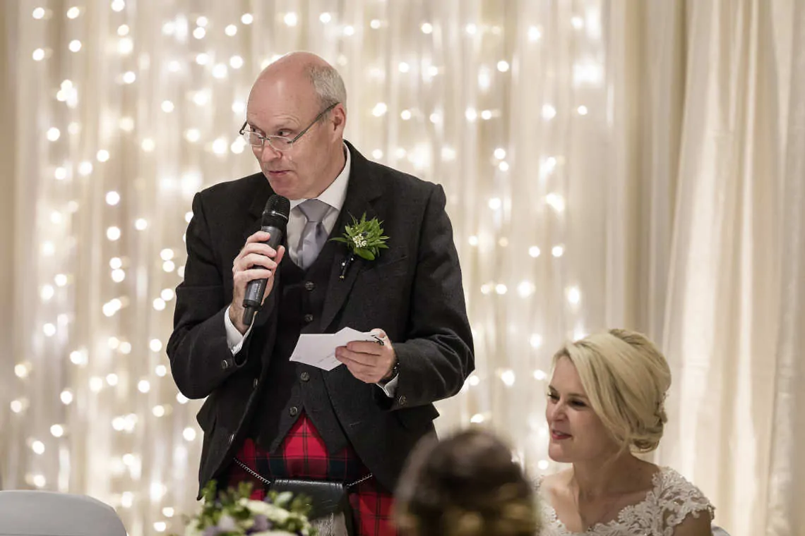 Father of the bride performs speech at reception