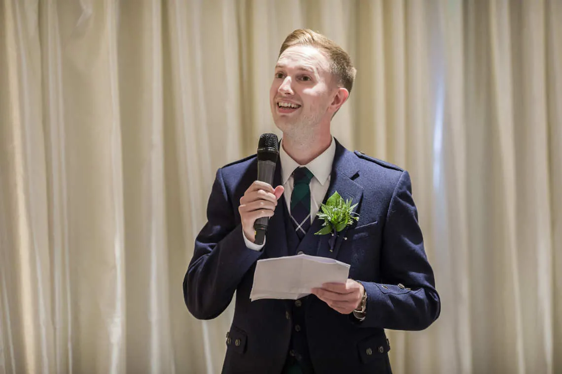 Best man gives speech at reception