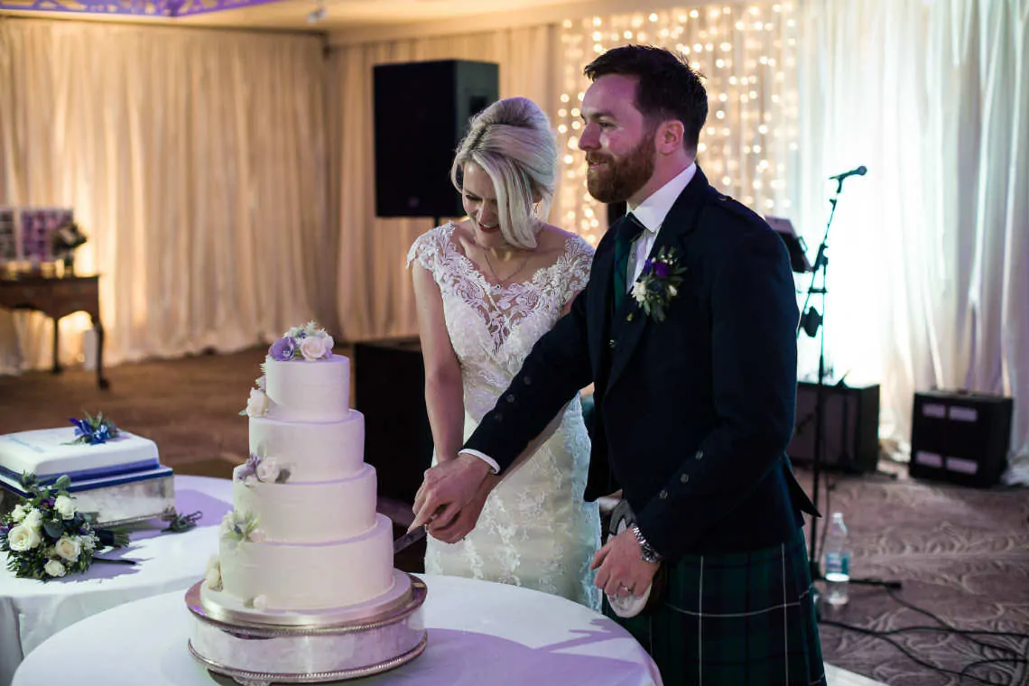 Newlyweds cut the wedding cake