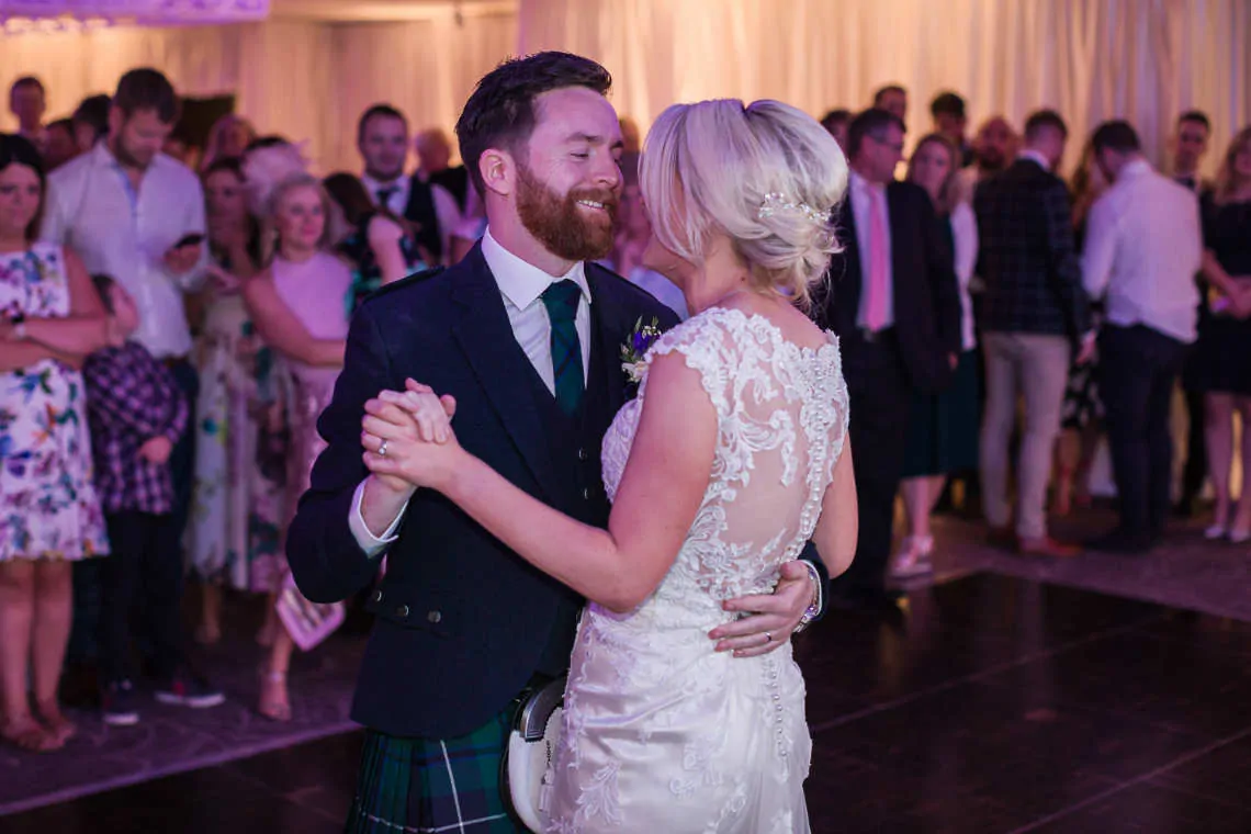 Newlyweds perform first dance at evening reception
