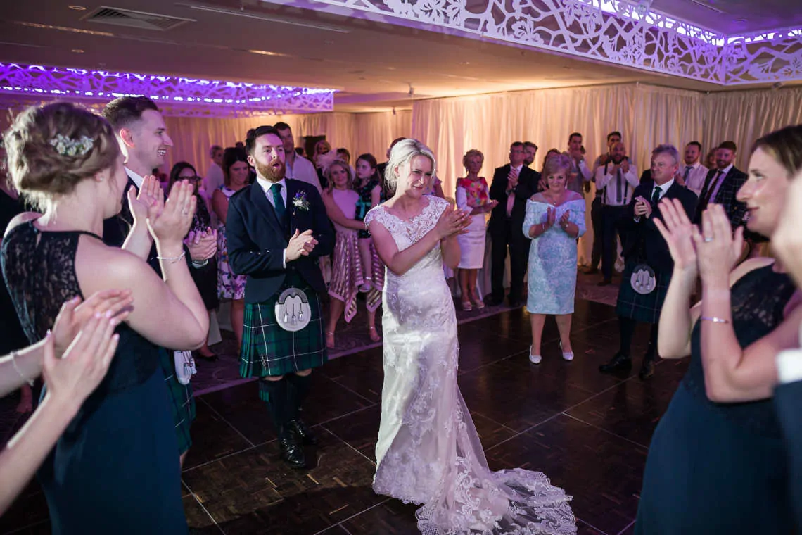 Bride and Groom clapping on dancefloor