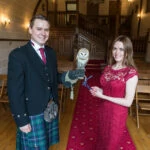 owl sits on the groom's gauntlet in the chapel