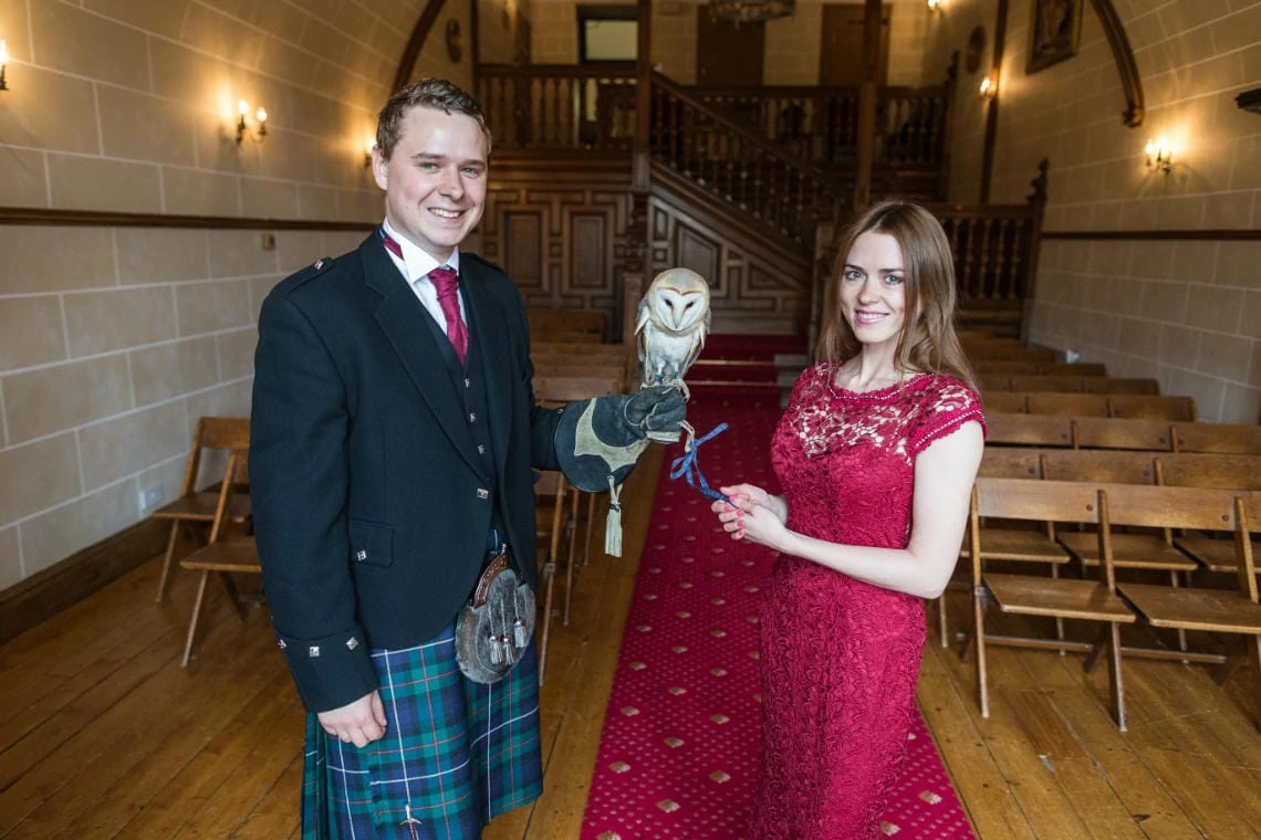 owl sits on the groom's gauntlet in the chapel