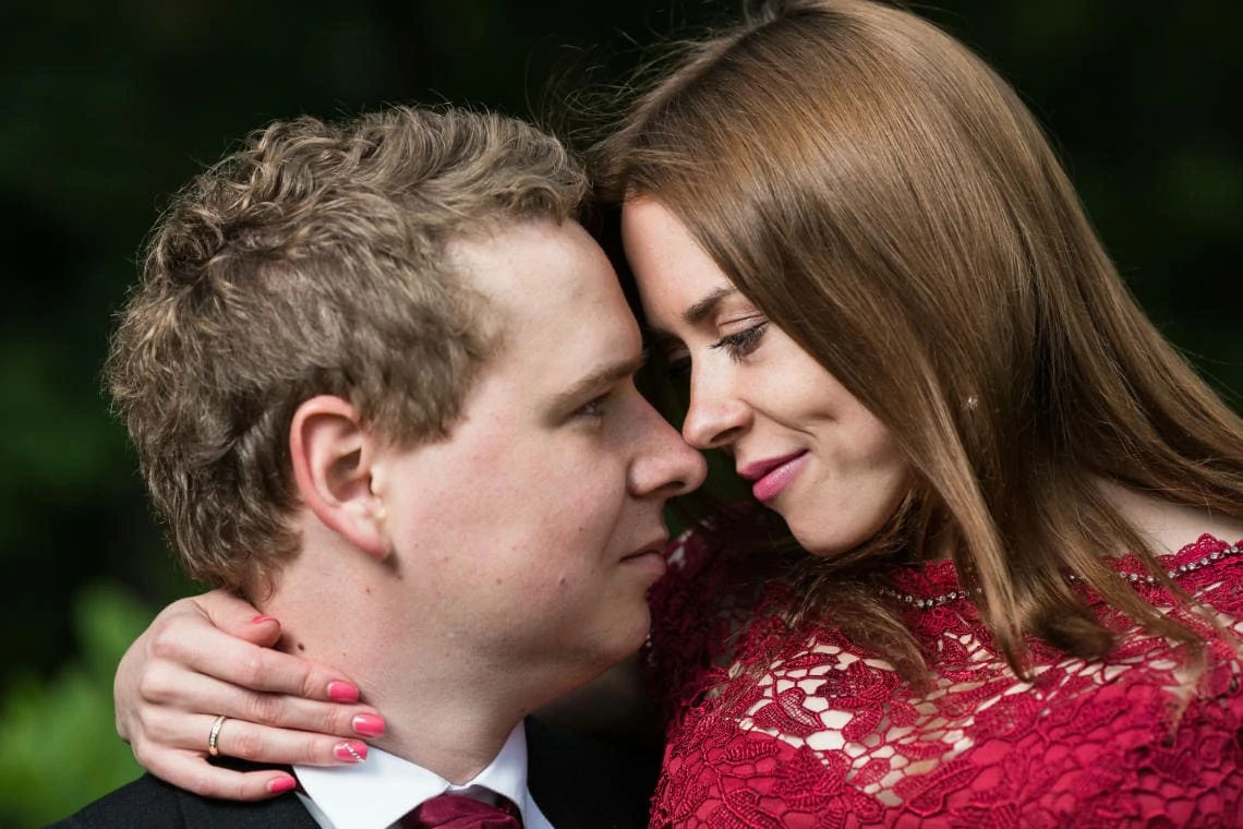 bride and groom embrace touching foreheads