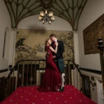 newlyweds embrace in front of the mural at reception