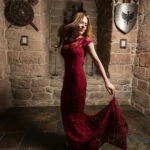 bride wearing a red lace dress dances in the Dungeon Gateside