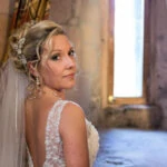bride looking back over her shoulder wearing a beautiful white dress