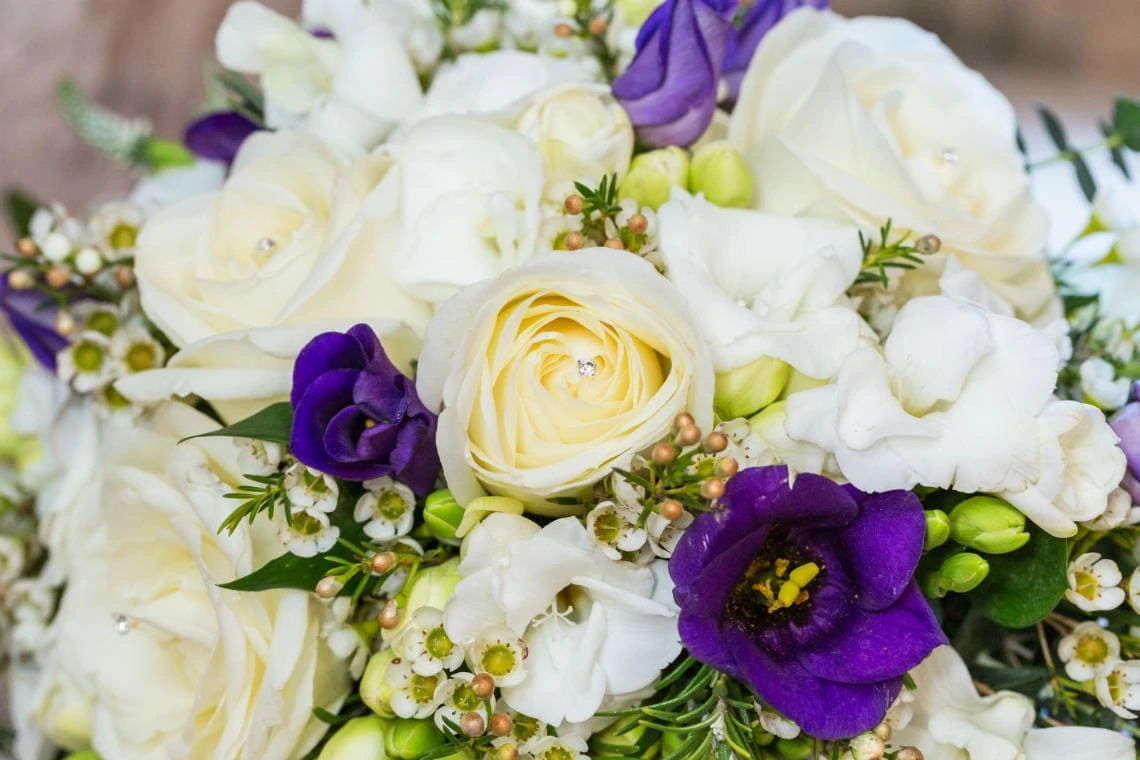 bridal bouquet of white and purple flowers with diamante details