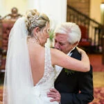 bride embraced by her tearful father a few minutes before she gets married