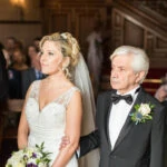 bride and father standing together in the chapel