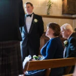guests watching marriage ceremony in the chapel