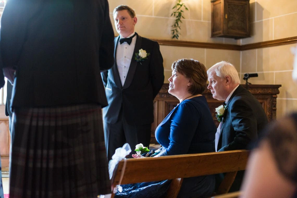 guests watching marriage ceremony in the chapel