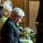 father bows his head as he listens to the exchange of vows
