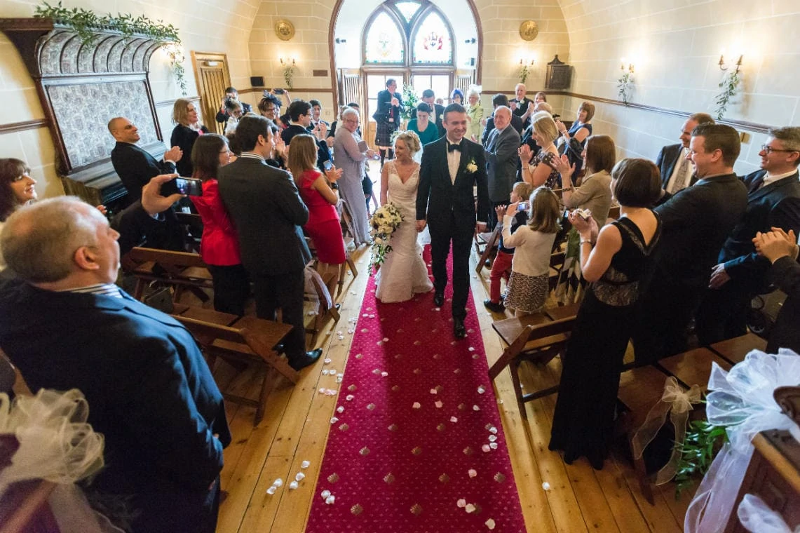 recessional from the chapel as newlyweds walk up the aisle