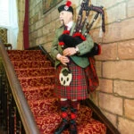 Piper Andrew Sharp plays the pipes to announce guests to make their way to dinner