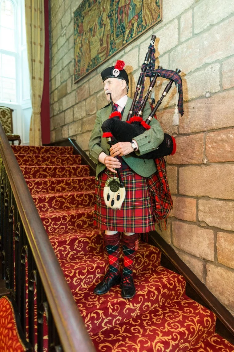 Piper Andrew Sharp plays the pipes to announce guests to make their way to dinner