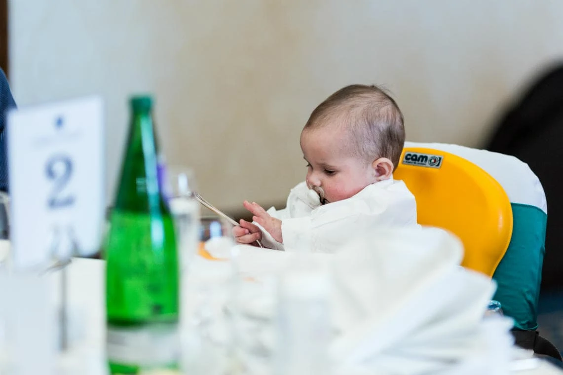 baby guest plays with cutlery