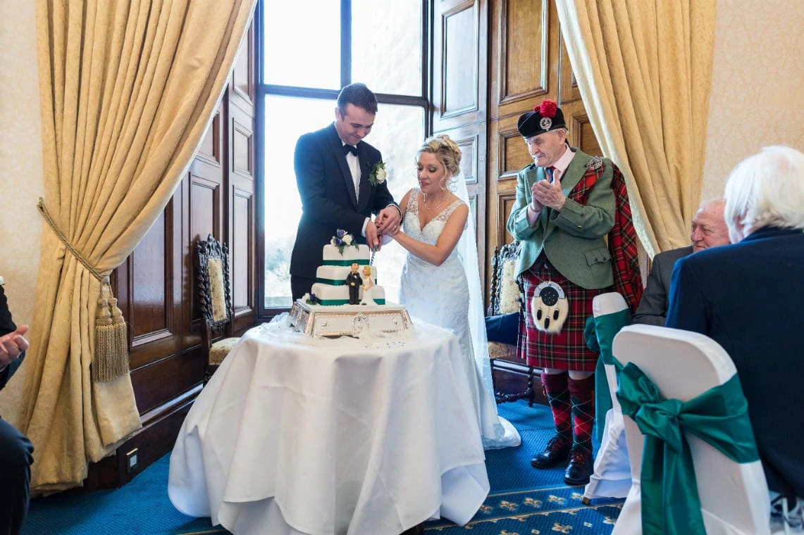 newlyweds cutting the cake in the Ramsay Suite