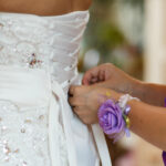 ribbon lacing at the back of bride's dress