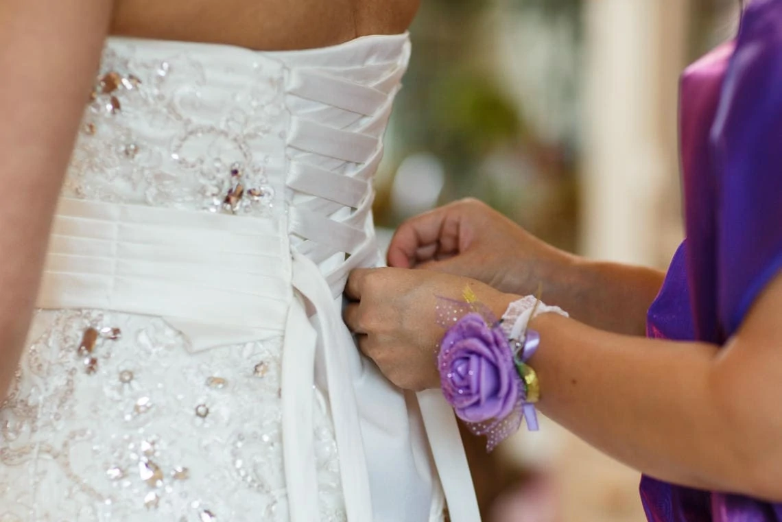 ribbon lacing at the back of bride's dress