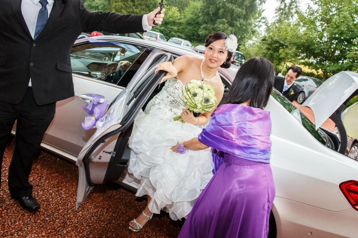 bride exits car upon arrival at Dalhousie Castle