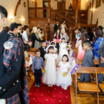 wedding processional as bridal party walk up the aisle in the chapel