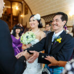 father of the bride shakes the groom's hand when handing over his daughter
