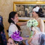 bride is congratulated by a female guest in the Sir Alexander Room