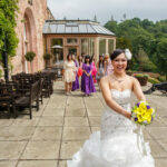 bride prepares to throw her bouquet on the castle's patio