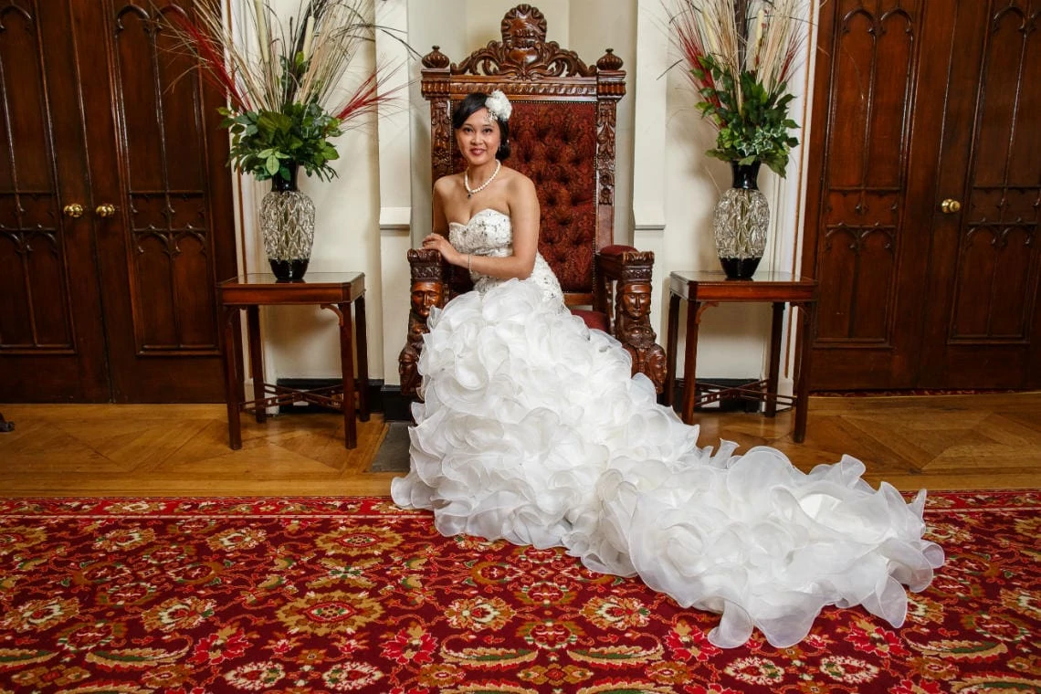 bride sitting on the throne in the castle's reception area